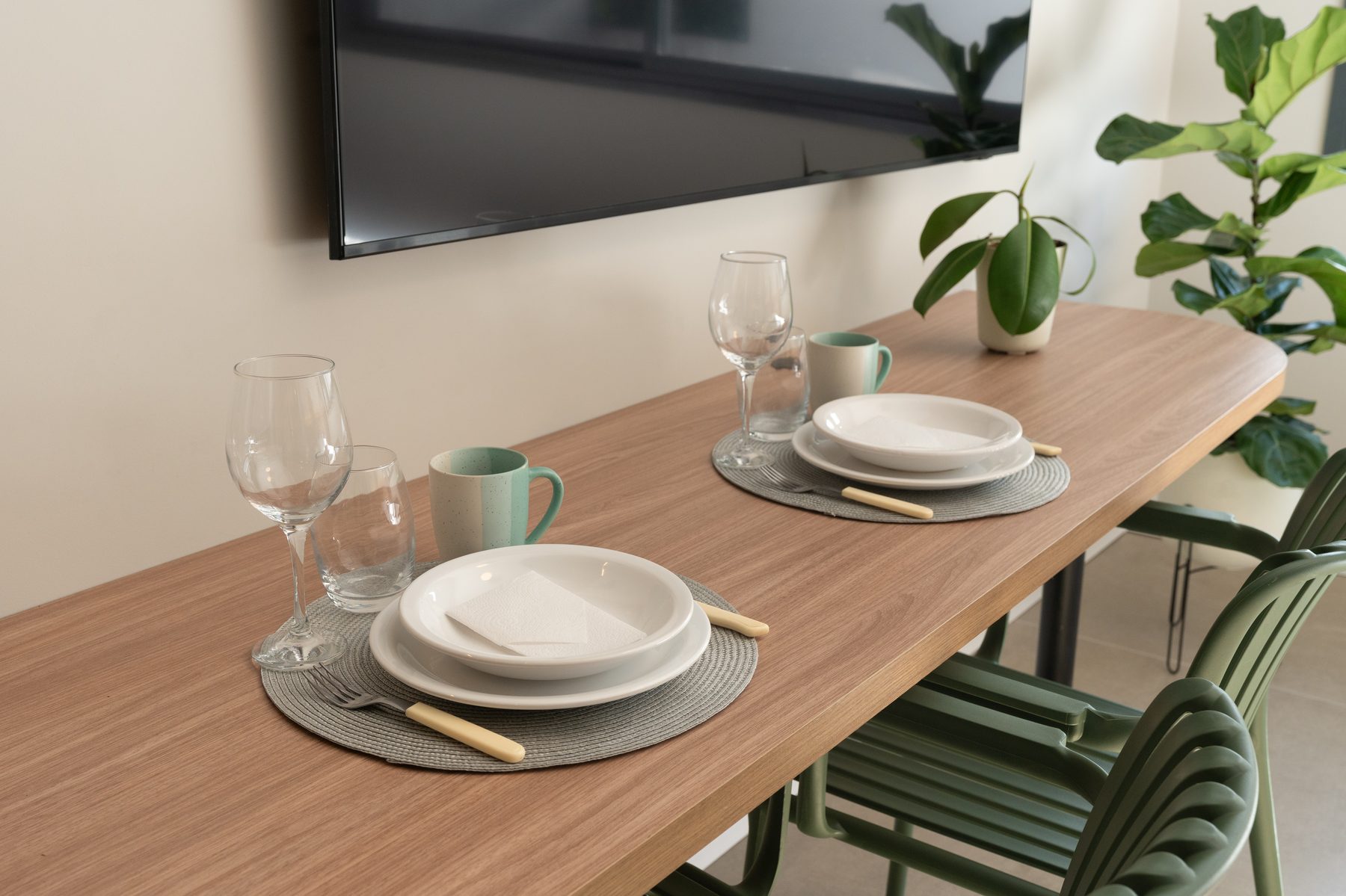 Mesa posta no Studio 215, com Smart TV ao fundo